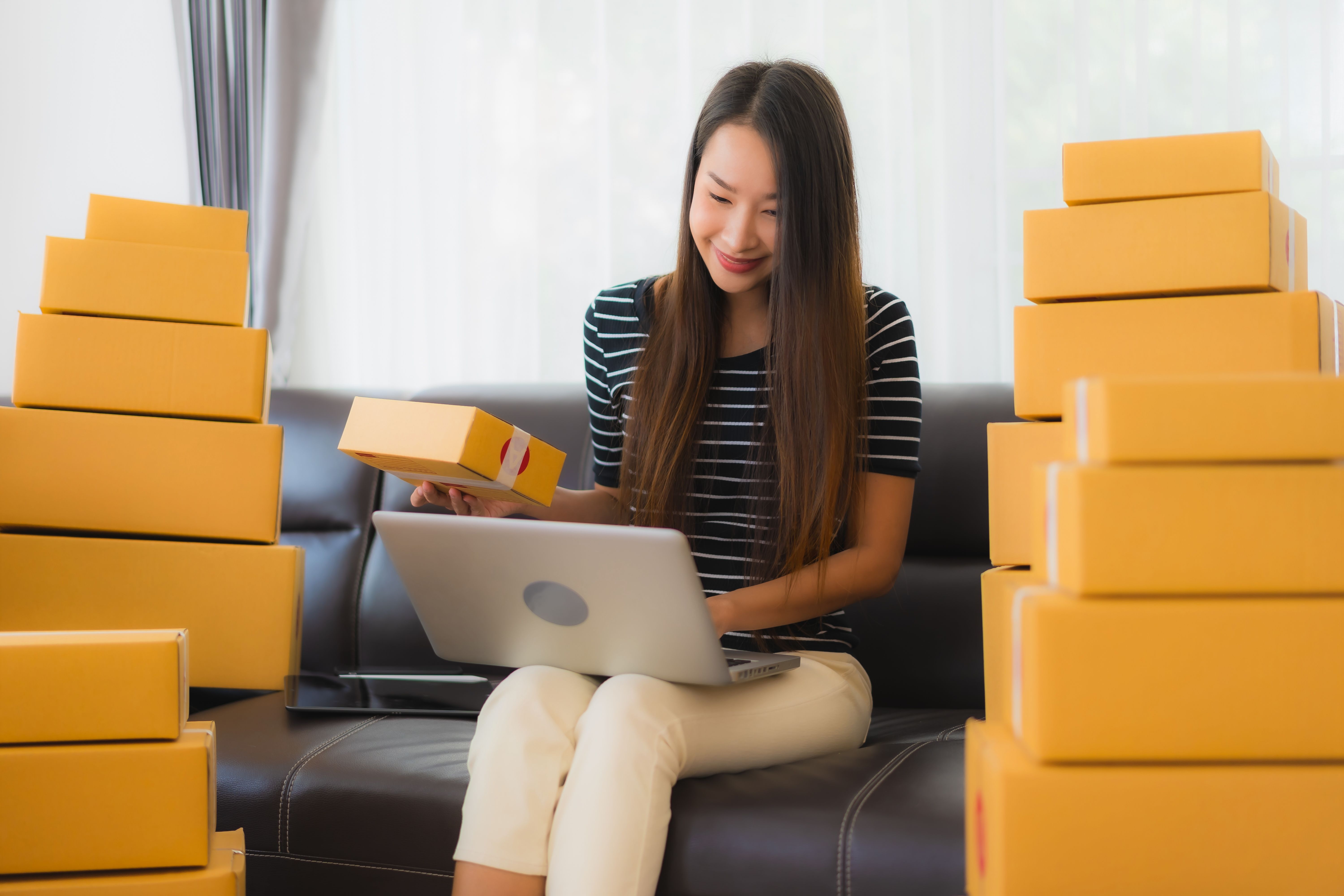 portrait-beautiful-young-asian-woman-with-cardboard-parcel-boxes-laptop.jpg
